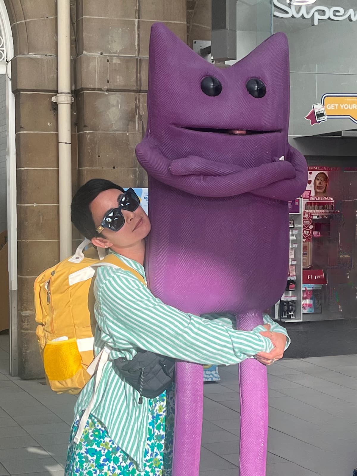 Emiko hugging a giant purple cat